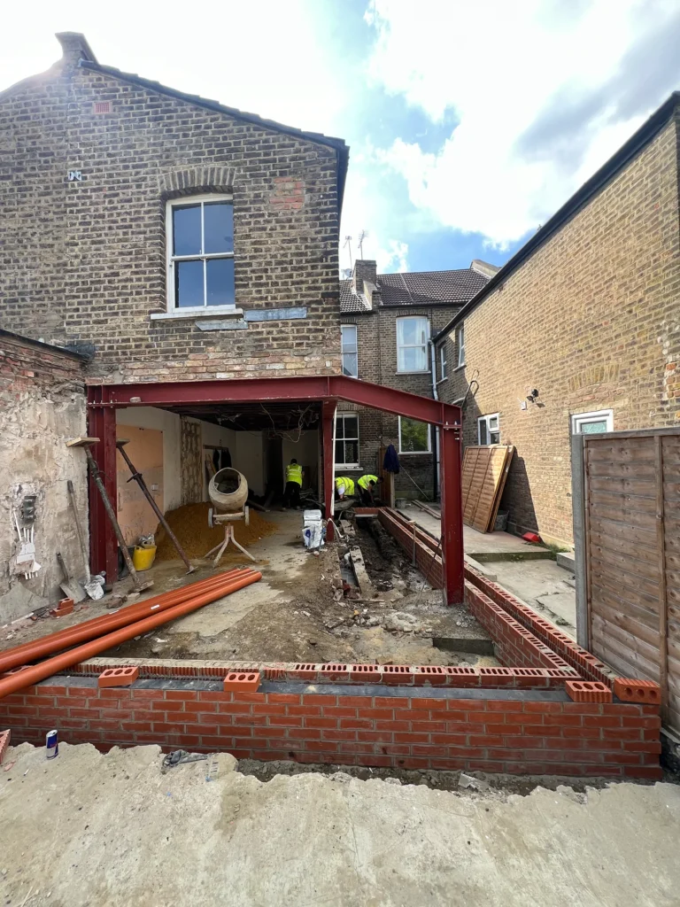 Structural demolition and steel beam installation for a rear house extension and refurbishment at Vale Road.