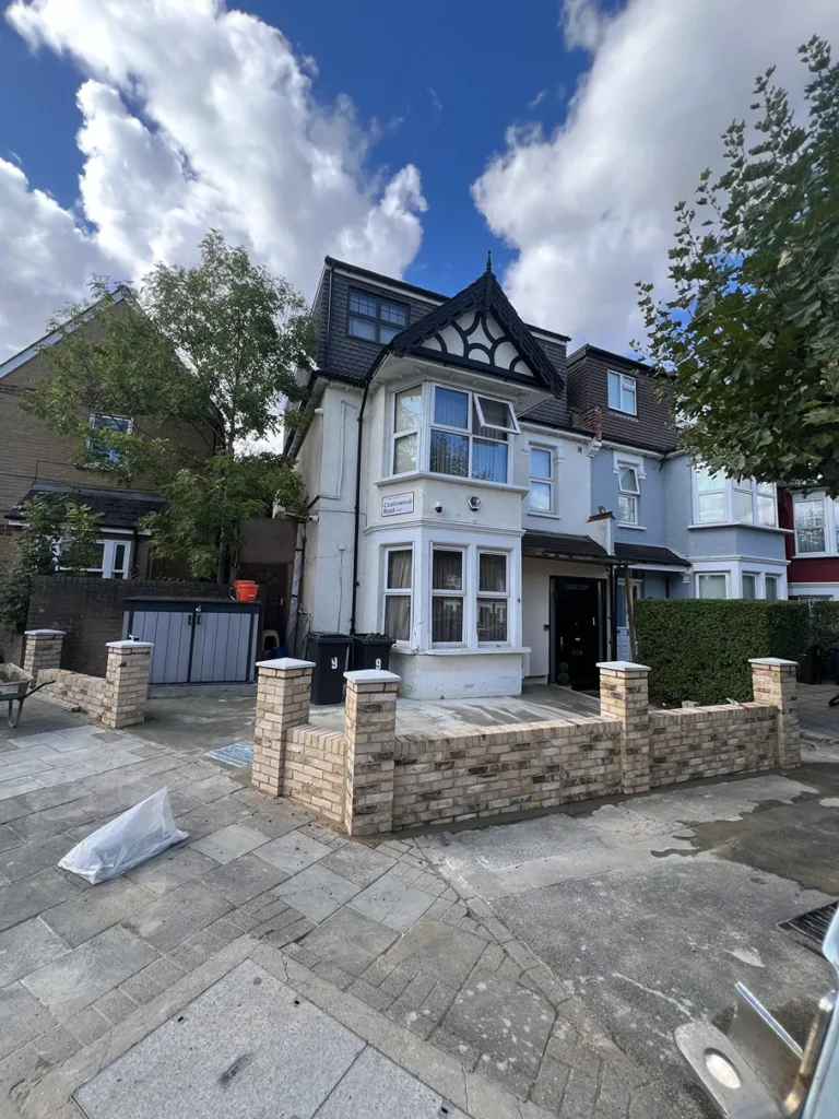 Excavation and ground preparation for a front driveway renovation in Stamford Hill, creating a level foundation for new construction.
